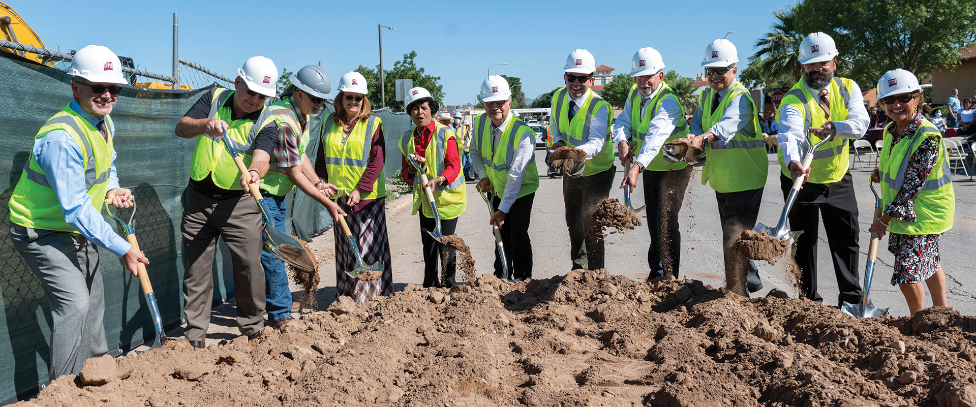 A group of people break ground